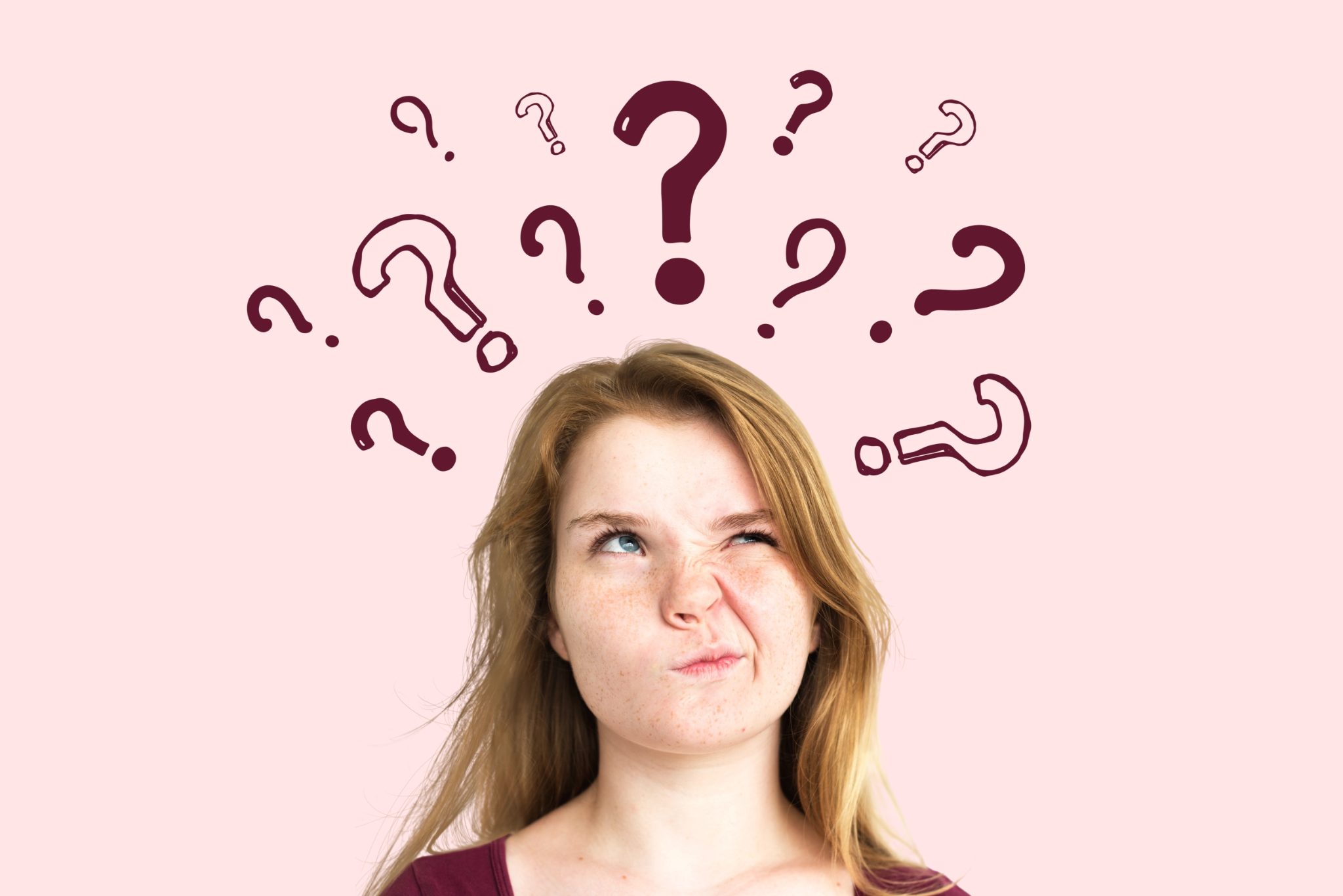 Puzzled woman looking up at question marks while working out a notice of intent to claim